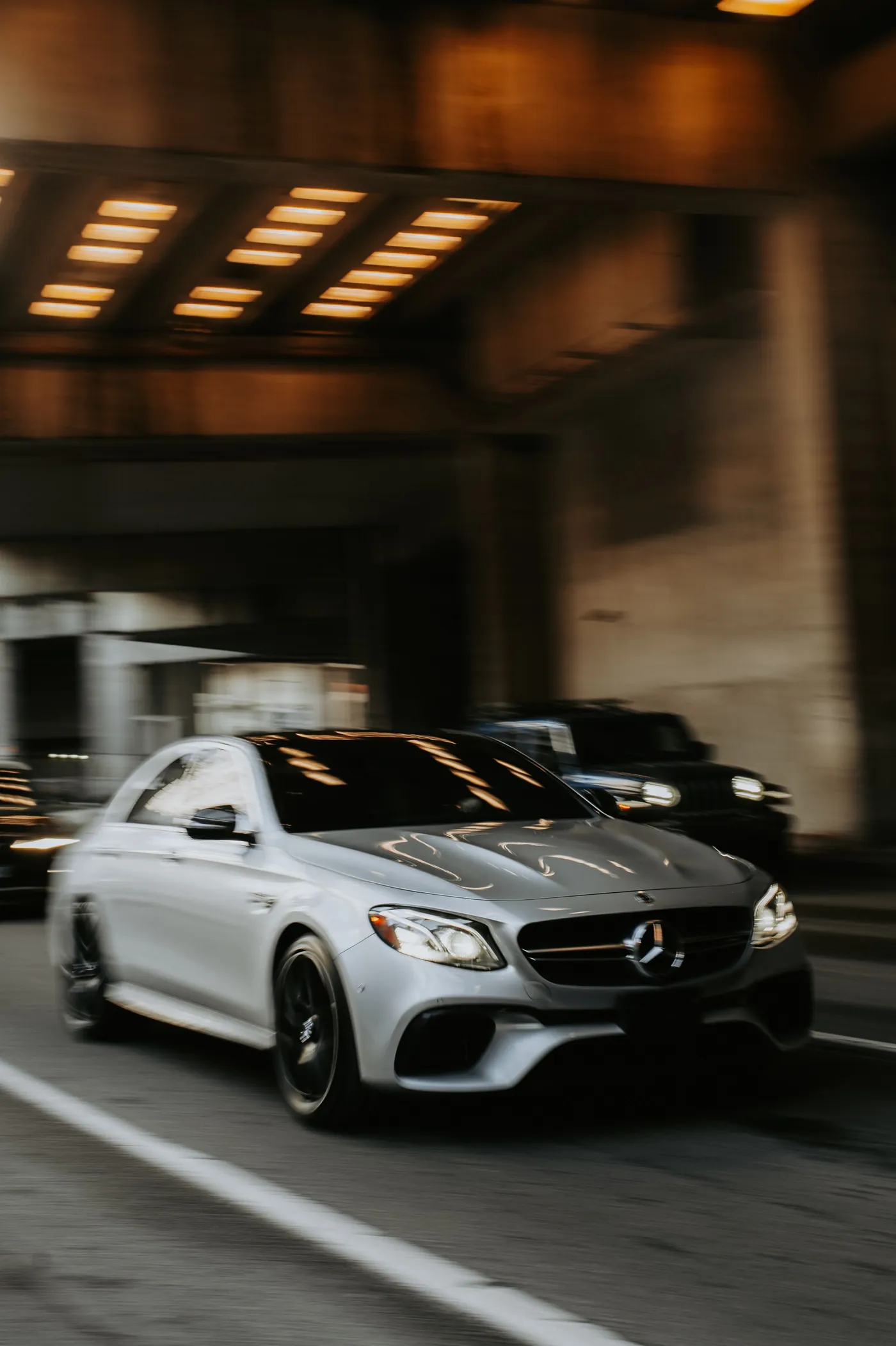 Luxury sedan arriving outside an upscale building